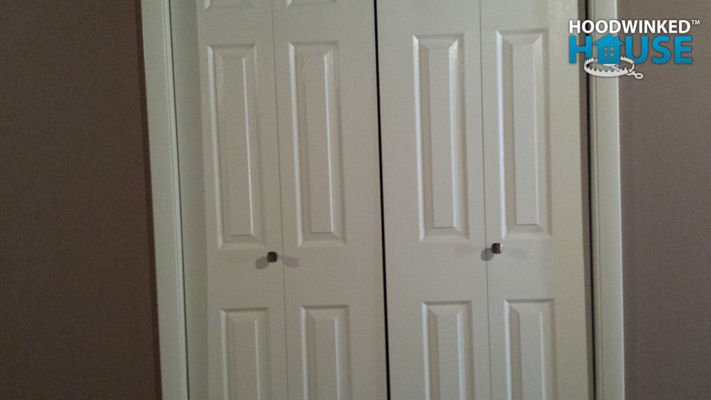 Bifold closet doors with handles installed on the wrong half of each door