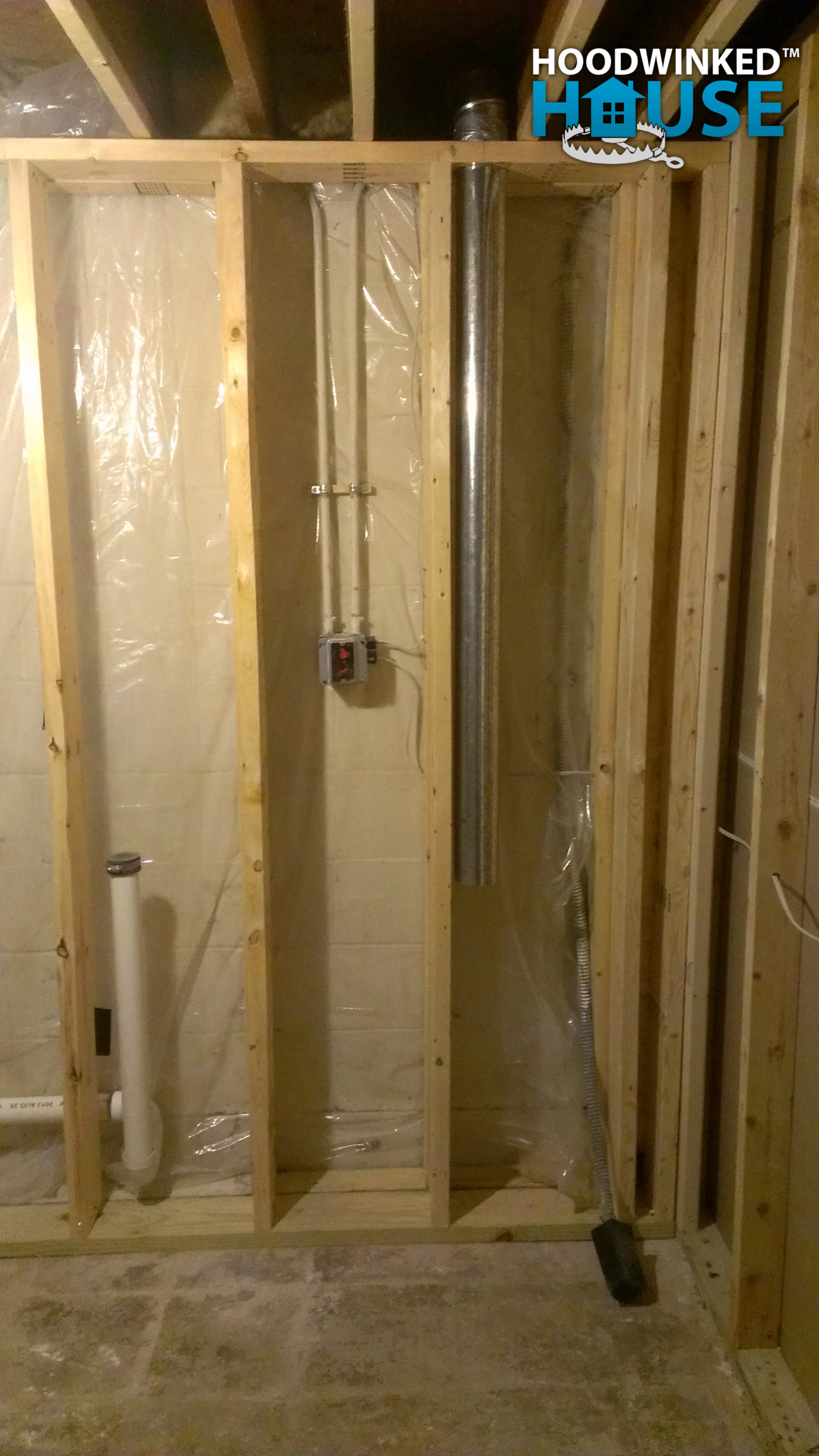Framing in a basement over drain pies and a dryer vent.