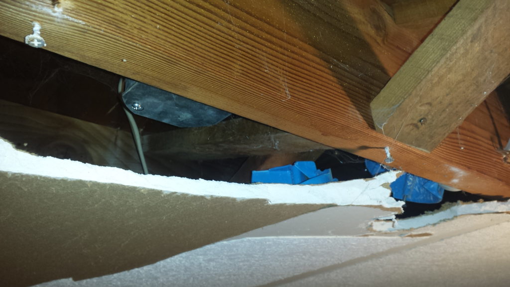 Demolition reveals more ceiling junction boxes hidden behind drywall.